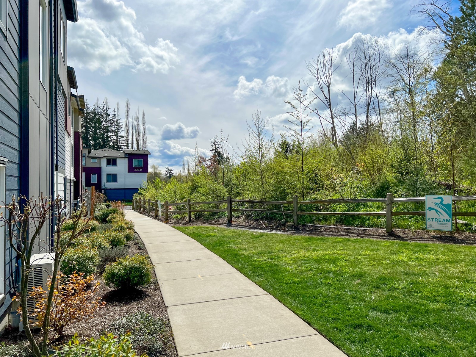509 237th Place Southeast, Unit E Bothell, WA 98021 - Photo 31 of 35 a view of a garden with plants and large trees