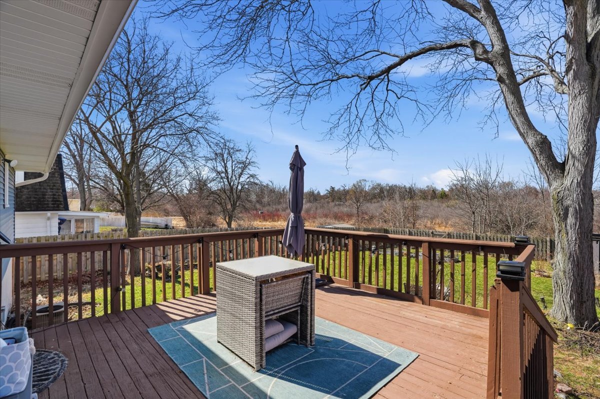 394 Northgate Road Lindenhurst, IL 60046 - Photo 25 of 28 a view of a wooden deck with trees in the background