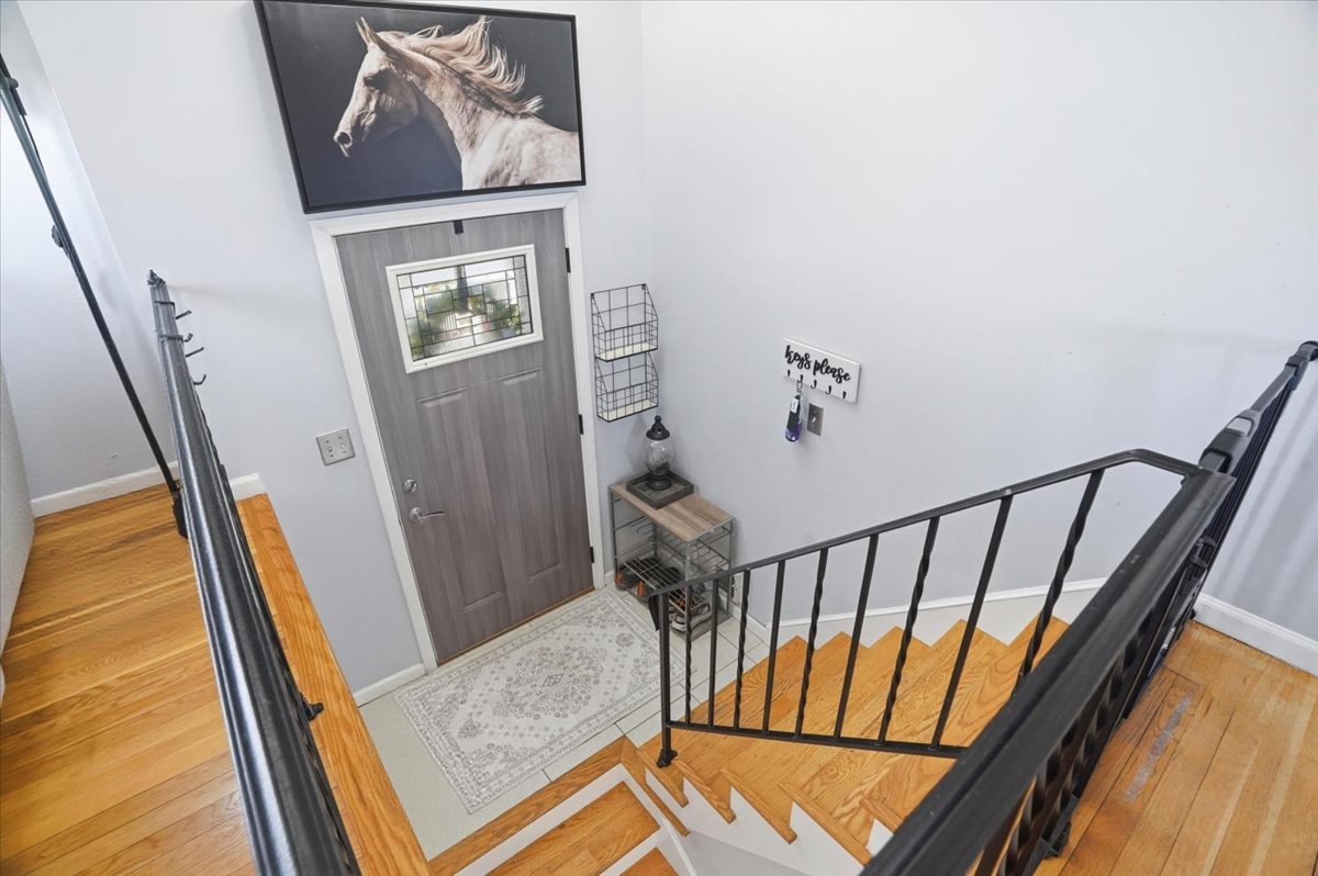 394 Northgate Road Lindenhurst, IL 60046 - Photo 3 of 28 a view of a hallway with wooden floor and stairs