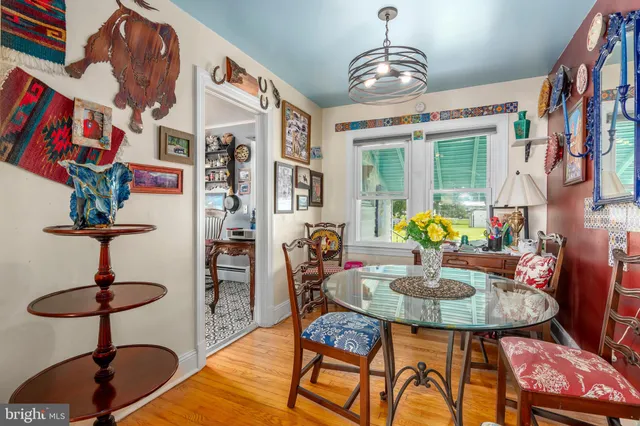 a kitchen with stainless steel appliances granite countertop a sink a stove a refrigerator cabinets and dining table