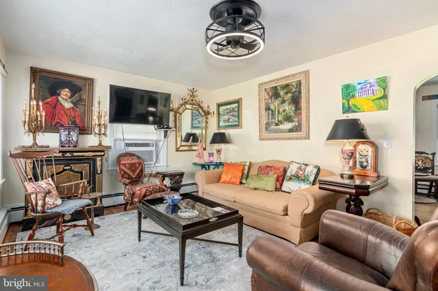 a living room with furniture a flat screen tv and a window