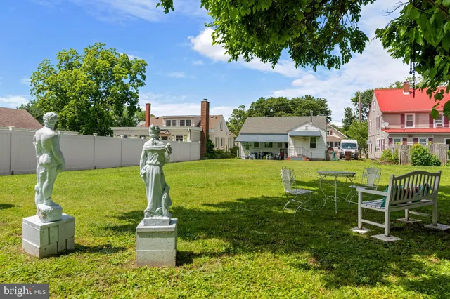 a front view of house with a garden