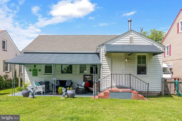 a front view of house with yard and outdoor seating