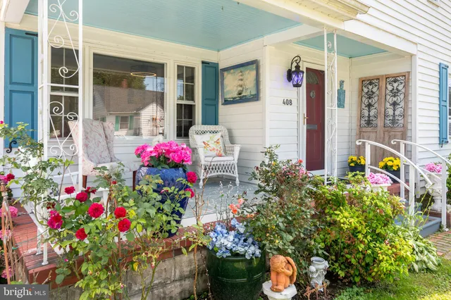 a flower plants sitting in front of the house