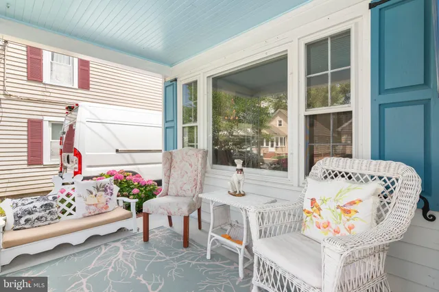 a living room filled with furniture and a potted plant