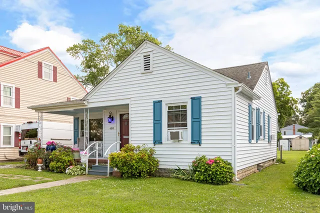 a front view of a house with a garden and plants