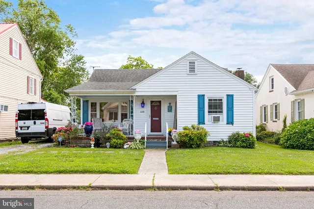 a front view of a house with a garden and plants