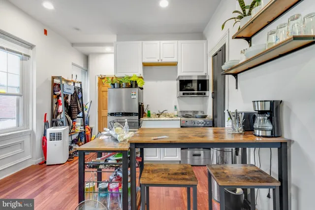 a kitchen with stainless steel appliances granite countertop a stove and cabinets