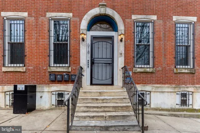 a view of a brick house with large windows