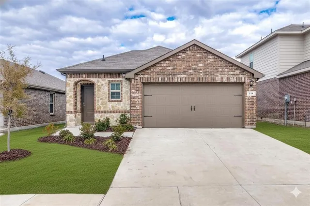 a front view of house with a garden