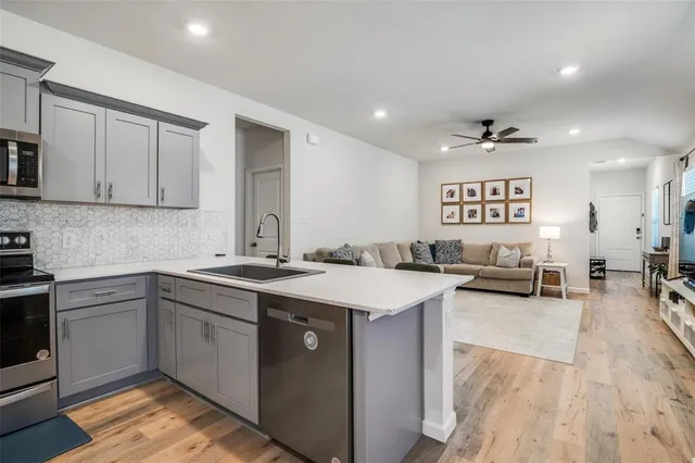 a kitchen with a sink stove and cabinets