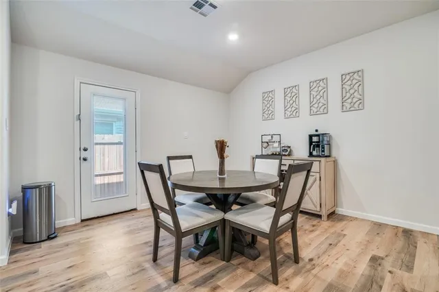 a dining room with furniture and wooden floor