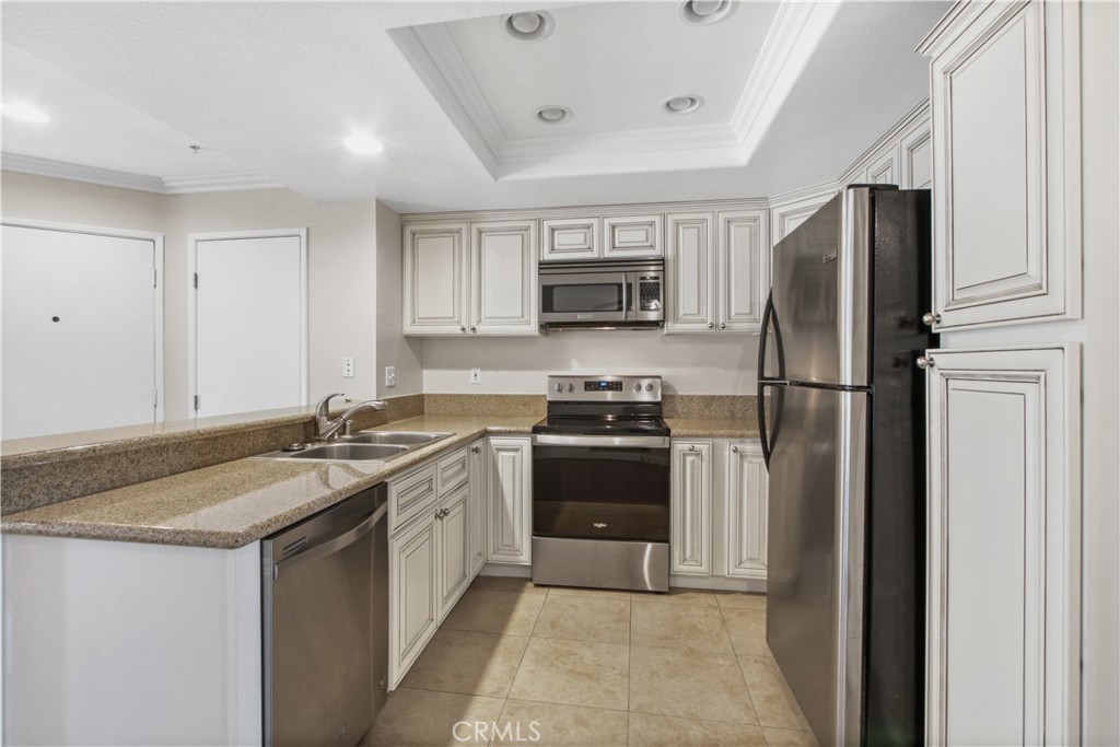 2800 Keller Drive, Unit 30 Tustin, CA 92782 - Photo 2 of 9 a kitchen with a refrigerator stove and sink