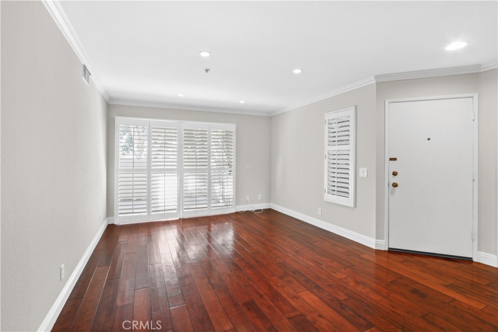 2800 Keller Drive, Unit 30 Tustin, CA 92782 - Photo 4 of 9 an empty room with wooden floor and windows