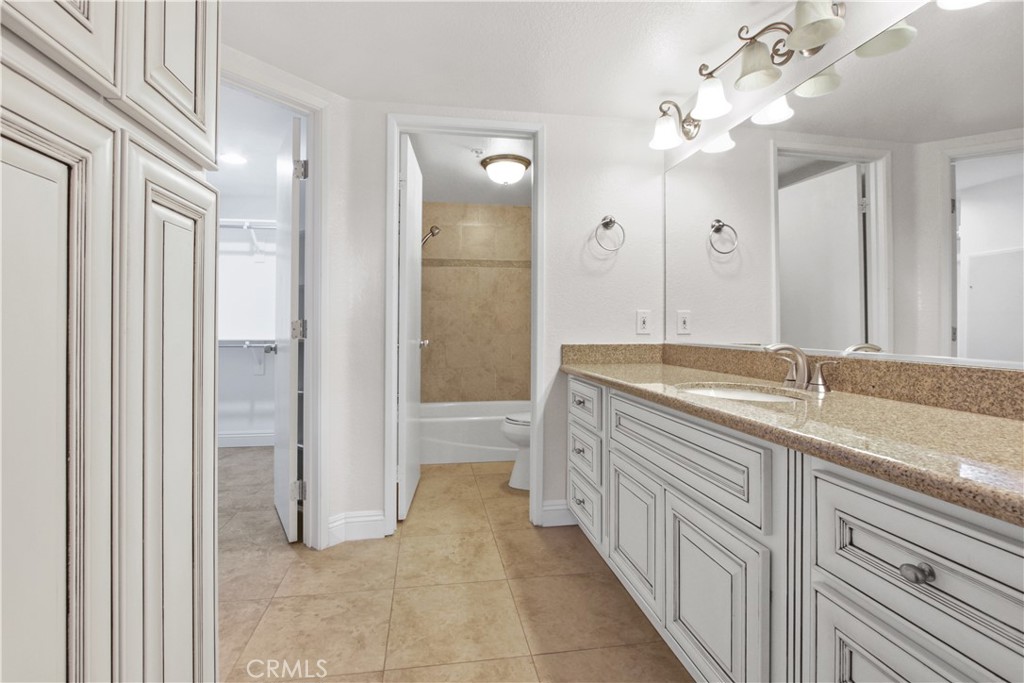 2800 Keller Drive, Unit 30 Tustin, CA 92782 - Photo 7 of 9 a spacious bathroom with a granite countertop sink a mirror a shower and a bathtub
