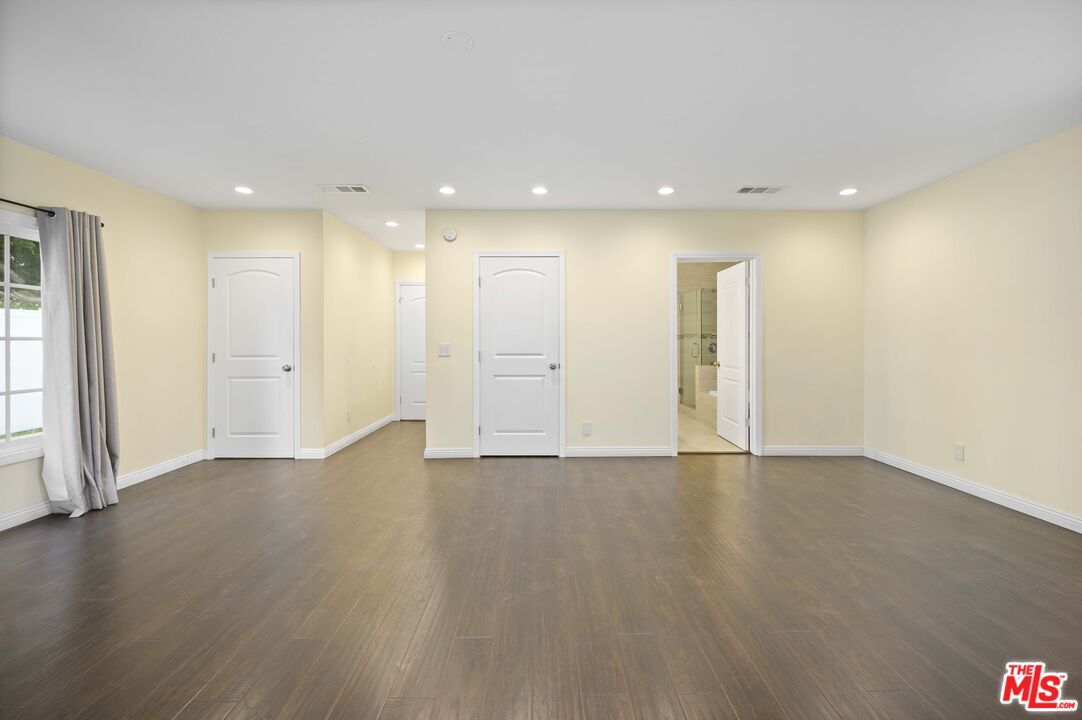 2148 Kelton Avenue Los Angeles, CA 90025 - Photo 14 of 36 an empty room with wooden floor and windows