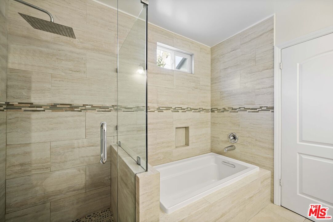 2148 Kelton Avenue Los Angeles, CA 90025 - Photo 17 of 36 a bathroom with a tub a sink and a shower