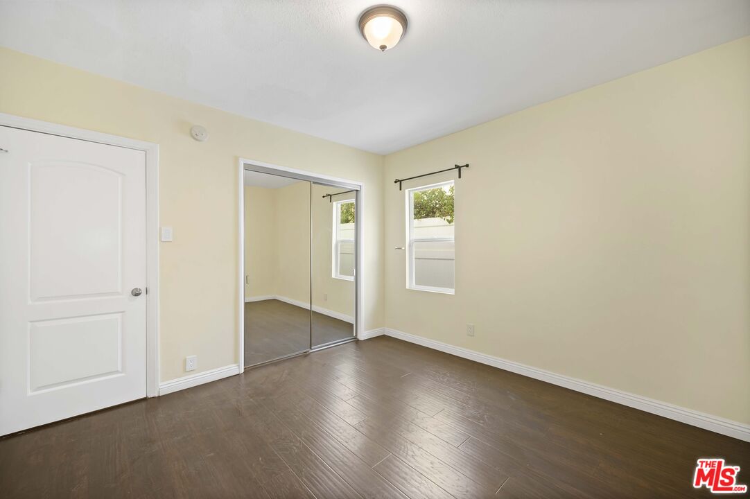 2148 Kelton Avenue Los Angeles, CA 90025 - Photo 20 of 36 an empty room with wooden floor and windows