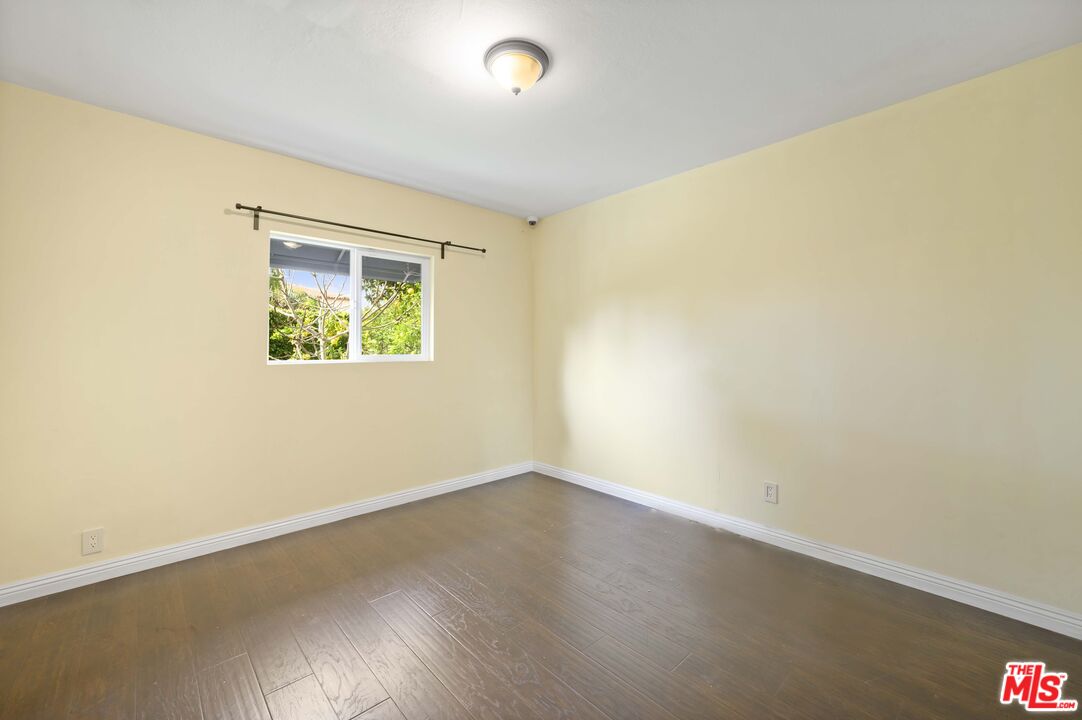 2148 Kelton Avenue Los Angeles, CA 90025 - Photo 23 of 36 an empty room with a wooden floor and a window