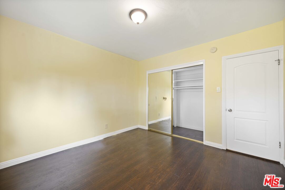 2148 Kelton Avenue Los Angeles, CA 90025 - Photo 24 of 36 an empty room with wooden floor and windows