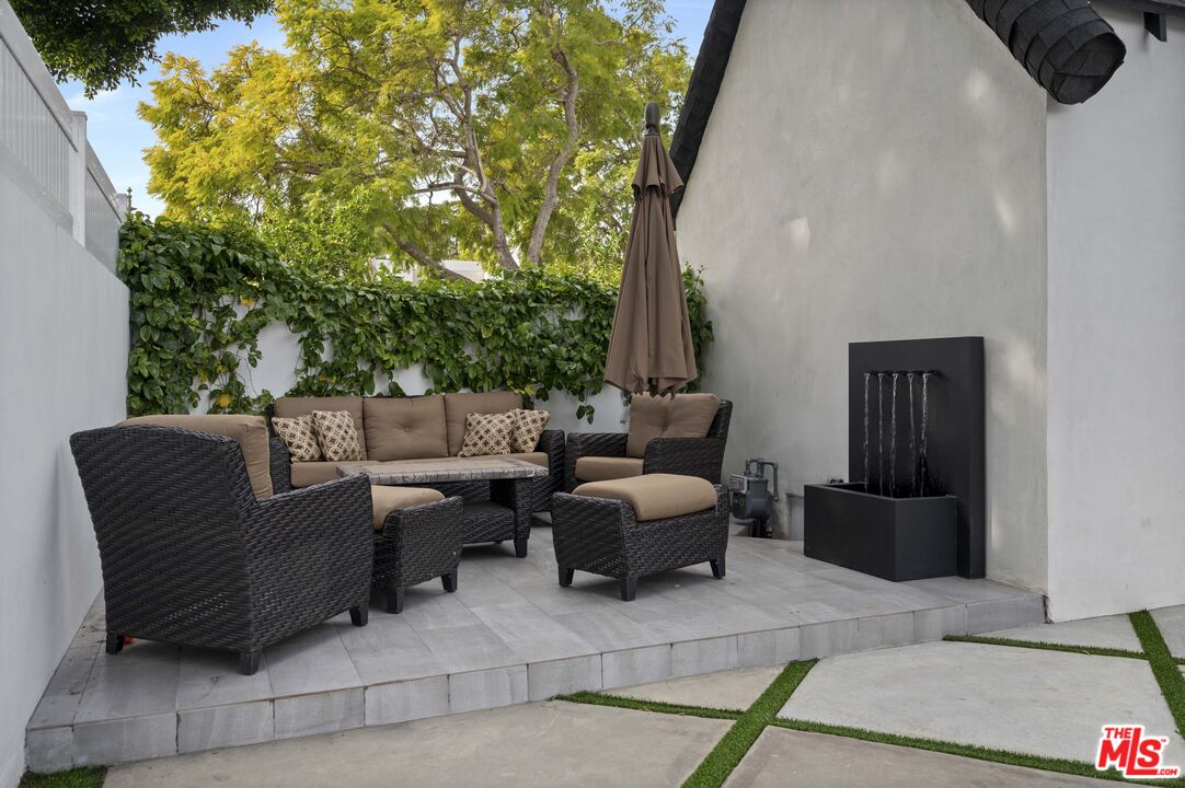 2148 Kelton Avenue Los Angeles, CA 90025 - Photo 29 of 36 a couple of chairs sitting in patio with a fireplace