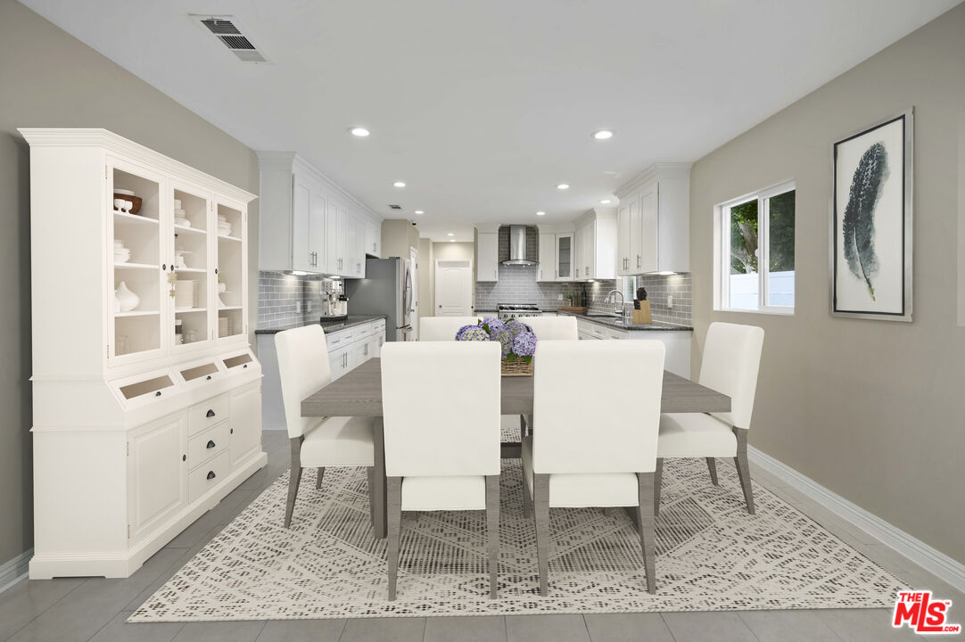 2148 Kelton Avenue Los Angeles, CA 90025 - Photo 3 of 36 a dining room with furniture a rug and kitchen view