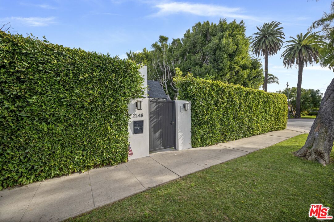 2148 Kelton Avenue Los Angeles, CA 90025 - Photo 34 of 36 a view of a backyard with potted plants and large trees