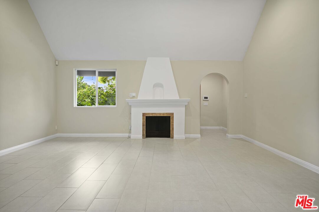 2148 Kelton Avenue Los Angeles, CA 90025 - Photo 5 of 36 an empty room with windows and fireplace