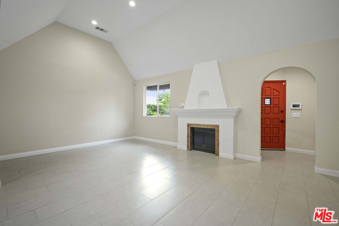 2148 Kelton Avenue Los Angeles, CA 90025 - Photo 6 of 36 an empty room with windows and fireplace