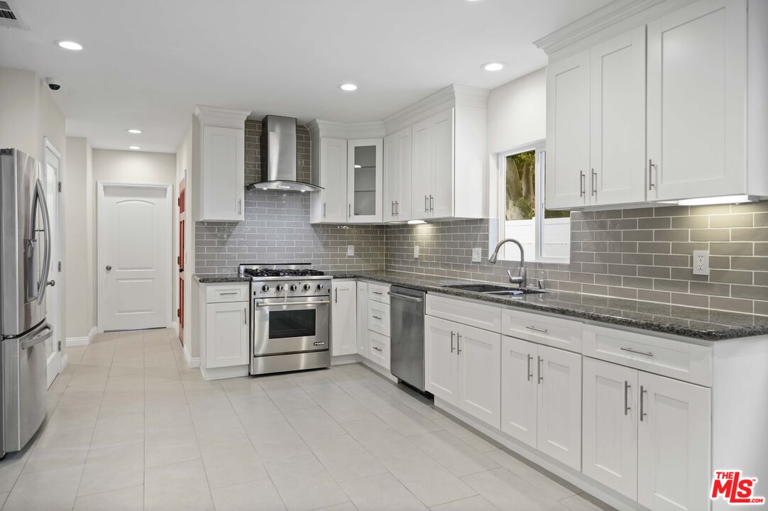 2148 Kelton Avenue Los Angeles, CA 90025 - Photo 8 of 36 a kitchen with granite countertop a sink stainless steel appliances and cabinets
