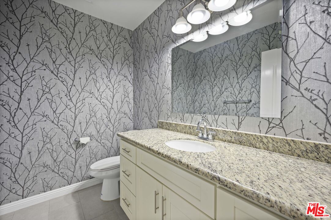 2148 Kelton Avenue Los Angeles, CA 90025 - Photo 10 of 36 a bathroom with a granite countertop sink and a toilet
