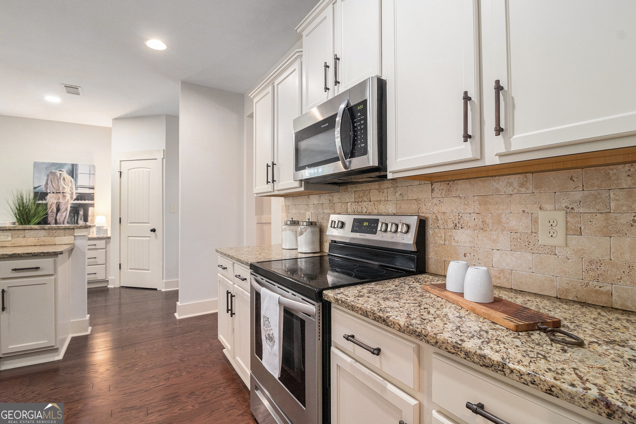 466 Austin Storey Circle Newnan, GA 30263 - Photo 11 of 38 a kitchen with stainless steel appliances granite countertop a stove a sink and a microwave