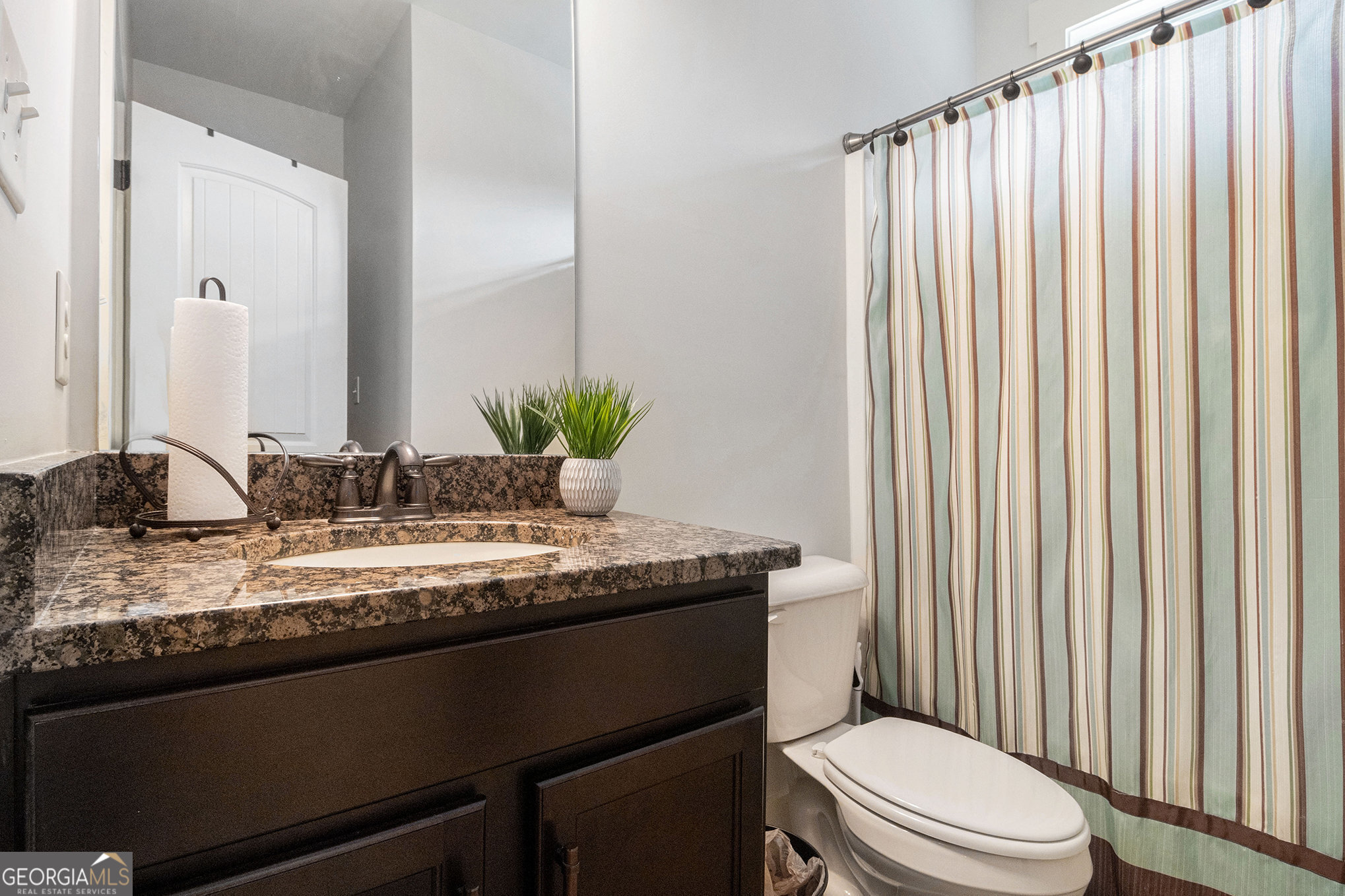 466 Austin Storey Circle Newnan, GA 30263 - Photo 14 of 38 a bathroom with a granite countertop sink toilet and mirror