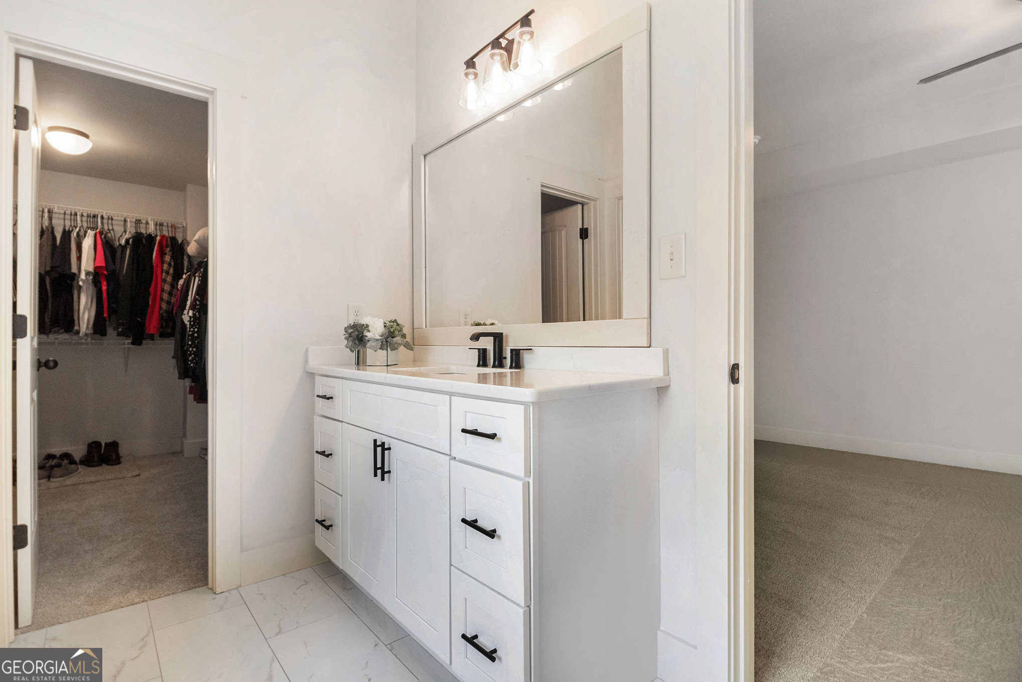 466 Austin Storey Circle Newnan, GA 30263 - Photo 25 of 38 a bathroom with a sink vanity and a mirror
