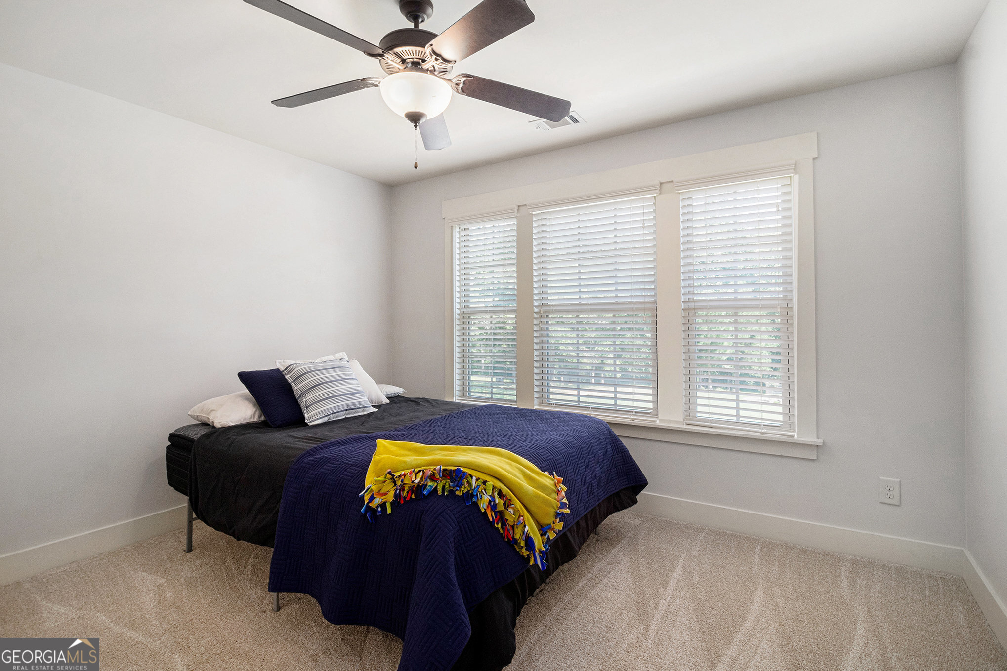466 Austin Storey Circle Newnan, GA 30263 - Photo 26 of 38 a bedroom with a bed and a window