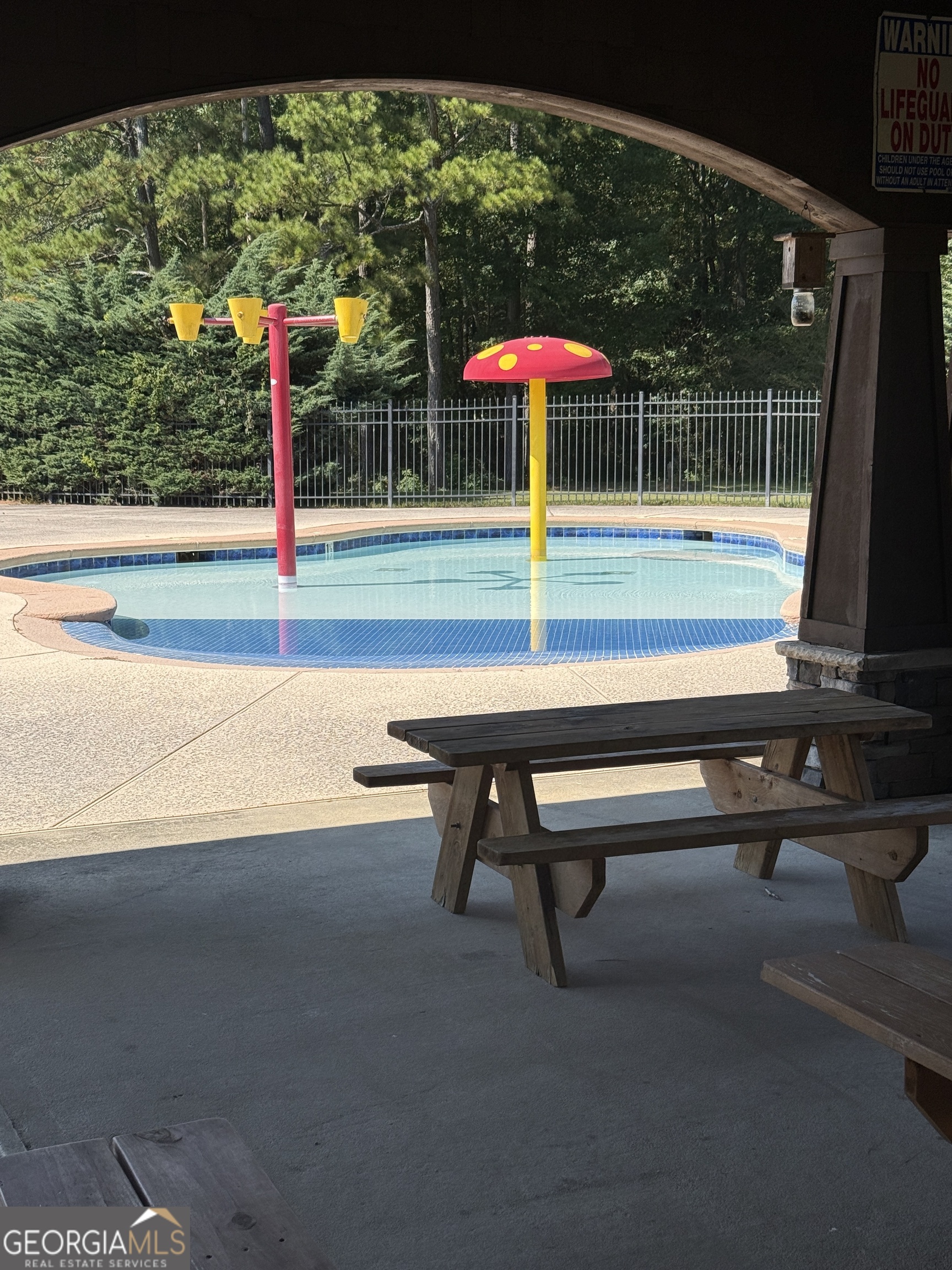 466 Austin Storey Circle Newnan, GA 30263 - Photo 36 of 38 a small park with a bench and tables