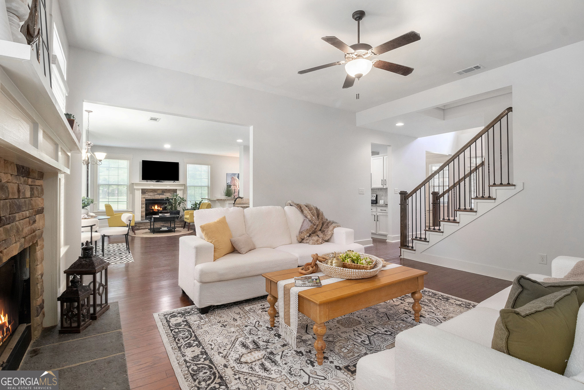 466 Austin Storey Circle Newnan, GA 30263 - Photo 4 of 38 a living room with furniture a fireplace and a chandelier