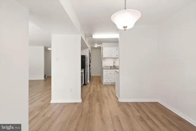 an empty room with a window and a ceiling fan