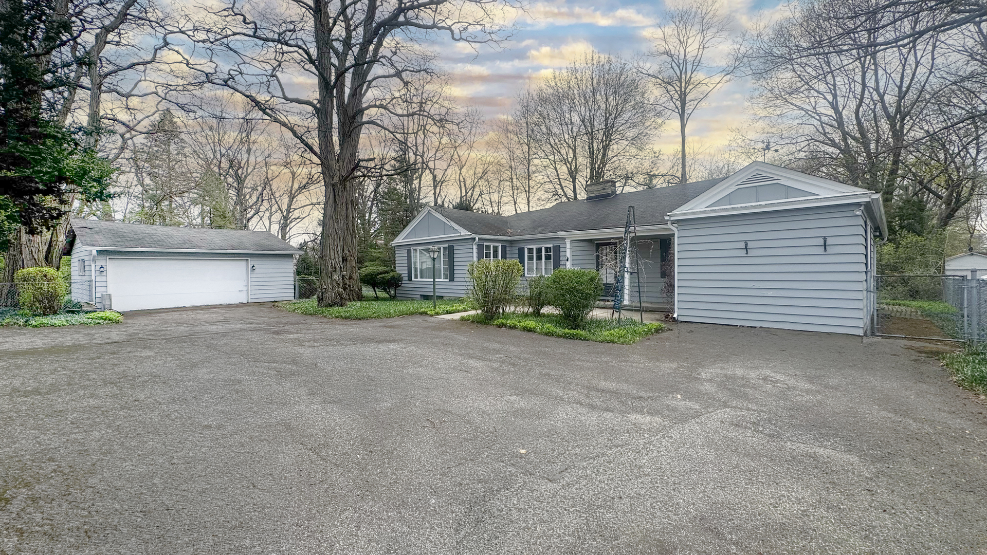 a view of a house with a yard and garage