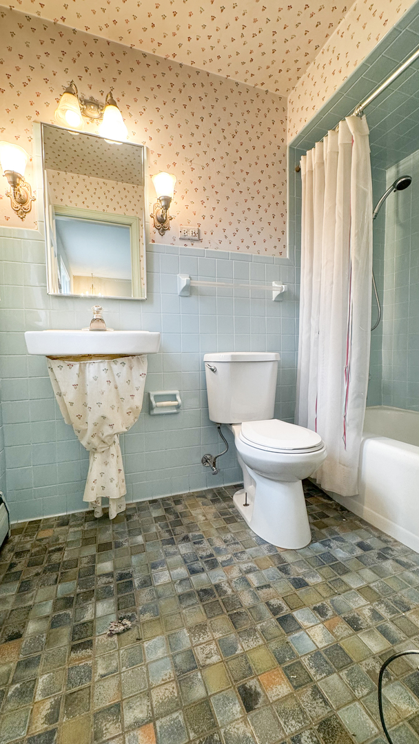 1848 North Sheridan Road Waukegan, IL 60087 - Photo 16 of 27 a bathroom with a toilet sink and mirror