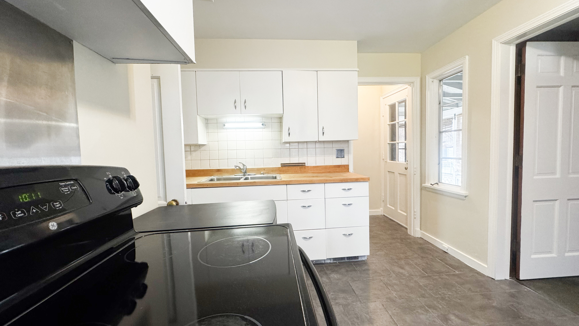 1848 North Sheridan Road Waukegan, IL 60087 - Photo 21 of 27 a kitchen with a refrigerator and white cabinets