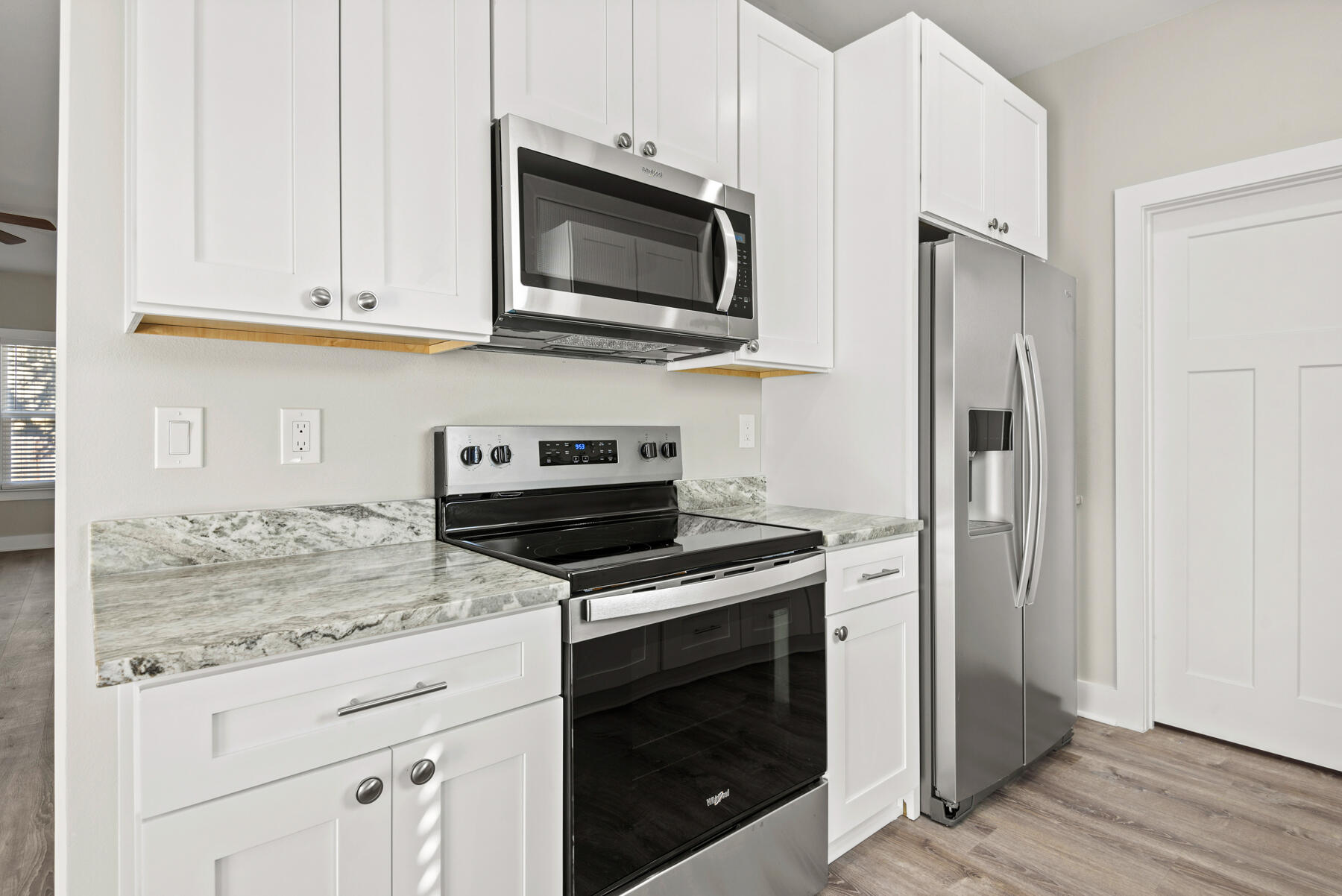 46 Winfield Street Niceville, FL 32578 - Photo 11 of 32 a kitchen with stainless steel appliances granite countertop a stove microwave and refrigerator