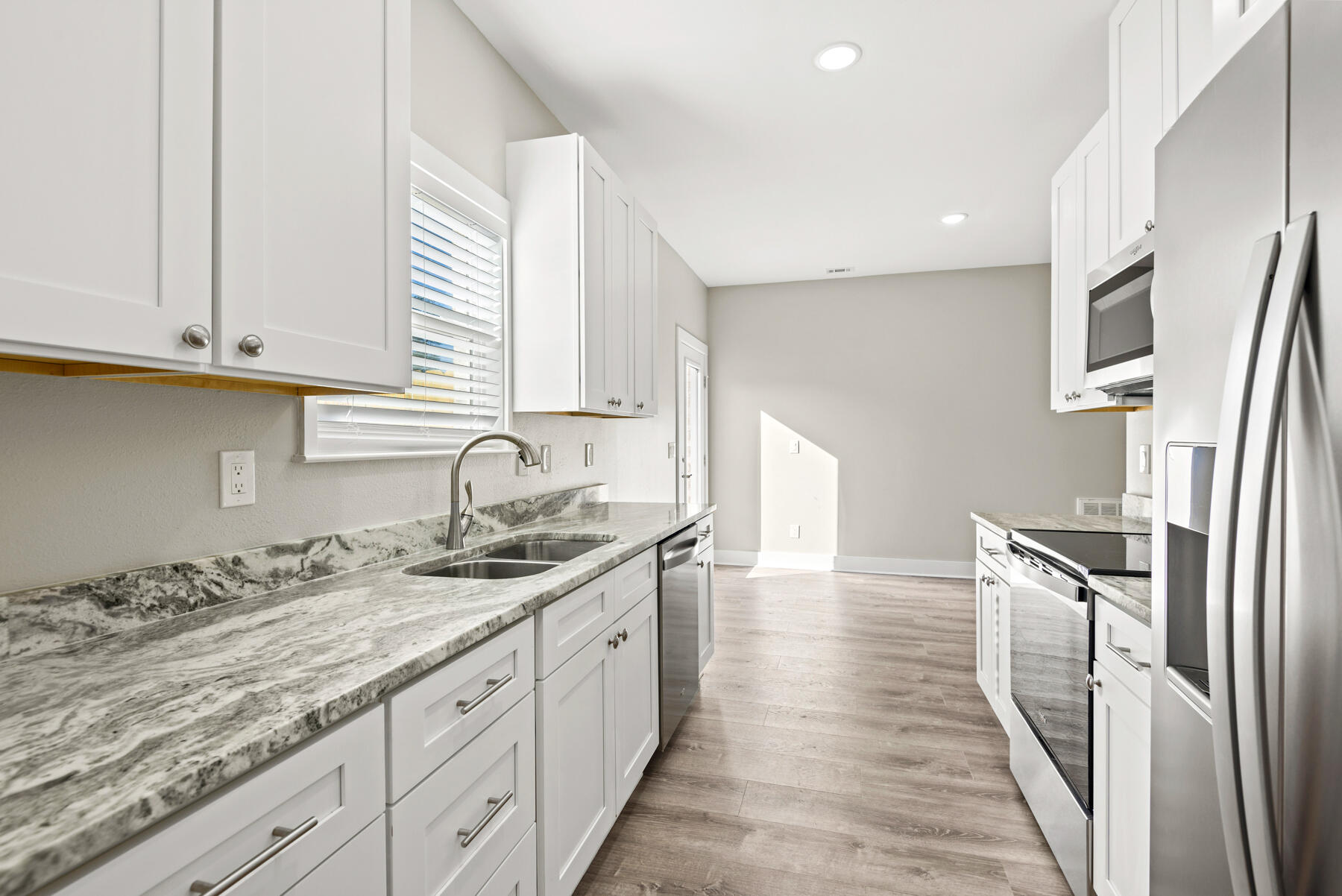46 Winfield Street Niceville, FL 32578 - Photo 13 of 32 a kitchen with granite countertop a sink and cabinets