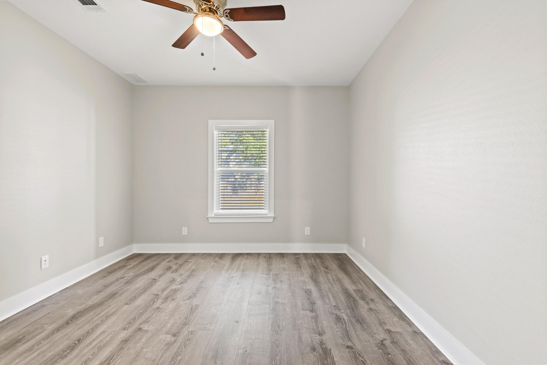 46 Winfield Street Niceville, FL 32578 - Photo 15 of 32 wooden floor in an empty room with a window