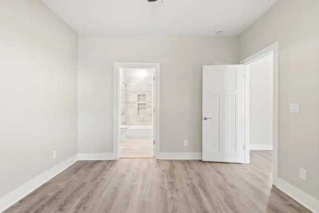 a view of an empty room with wooden floor