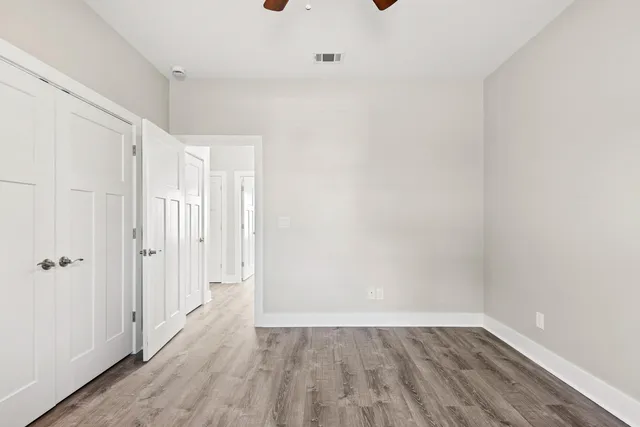 a view of a room with wooden floor