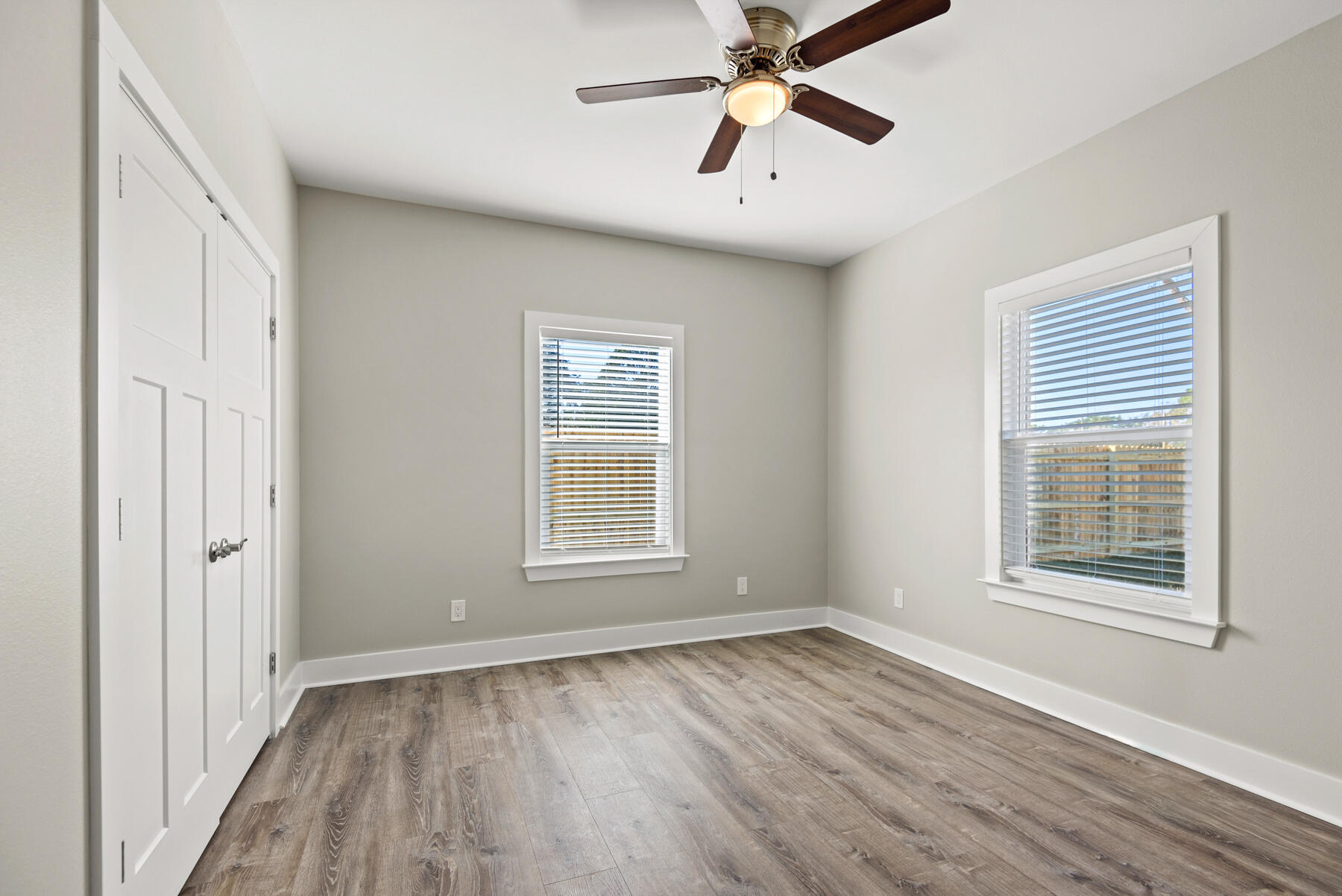 46 Winfield Street Niceville, FL 32578 - Photo 22 of 32 an empty room with wooden floor fan and windows