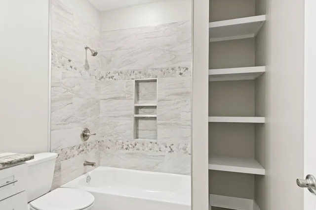 a bathroom with a bathtub and a toilet