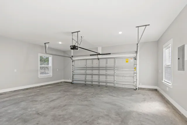 an empty room with windows and closet