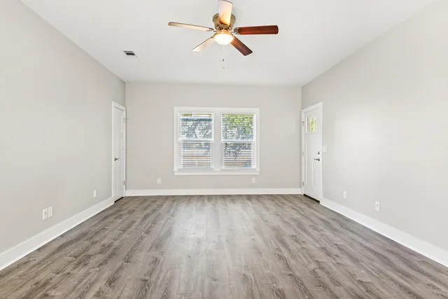 wooden floor in an empty room with a window